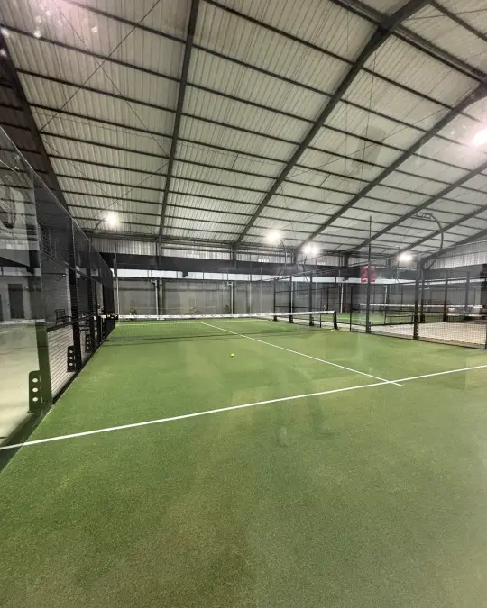 Green turf court behind the glass